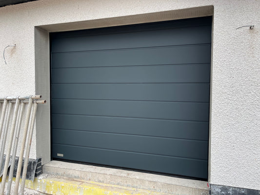 Sectional garage door insulated panels